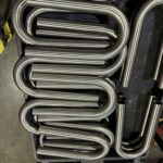 A stack of custom mandrel bends for industrial use