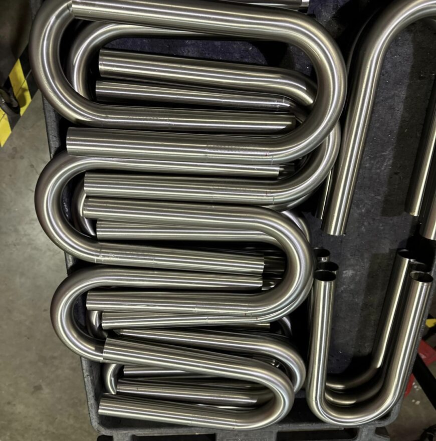 A stack of custom mandrel bends for industrial use